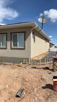 a house under construction with a satellite dish